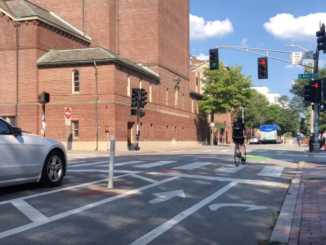 A cyclist rides through the intersection of Mt. Auburn and DeWolfe streets in Cambridge.