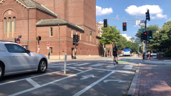 A cyclist rides through the intersection of Mt. Auburn and DeWolfe streets in Cambridge.