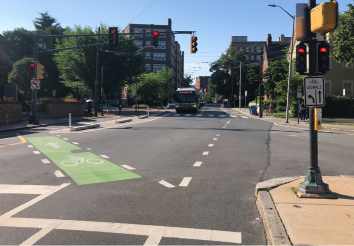 The intersection of Garden Street and Concord Avenue, which has a nearside bicycle signal and related signage.